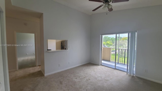 unfurnished room with ceiling fan and light carpet