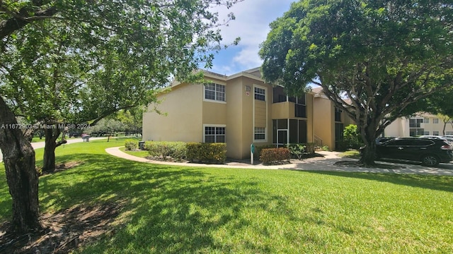 view of side of home with a yard