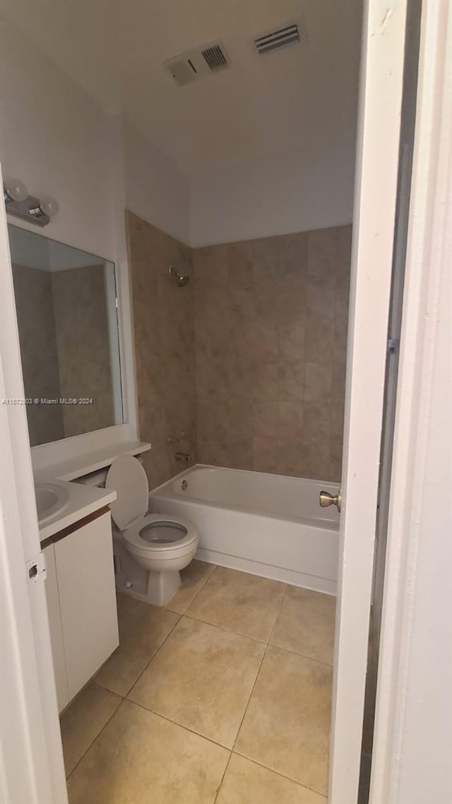 full bathroom featuring tile patterned floors, toilet, vanity, and tiled shower / bath combo