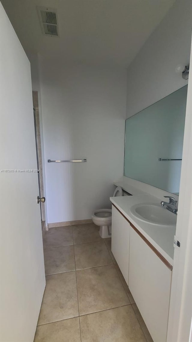 bathroom featuring tile patterned floors, toilet, and vanity