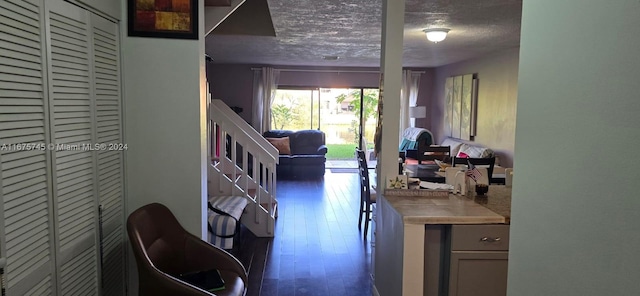 kitchen with dark wood-type flooring and a textured ceiling