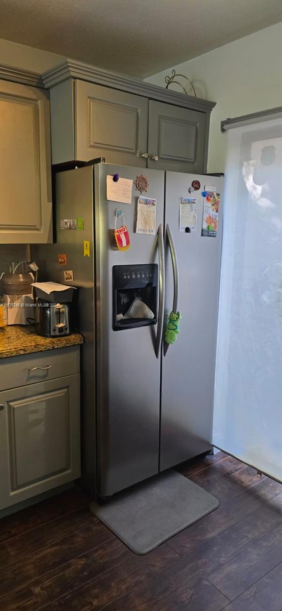 kitchen featuring gray cabinets, dark hardwood / wood-style floors, and stainless steel fridge with ice dispenser