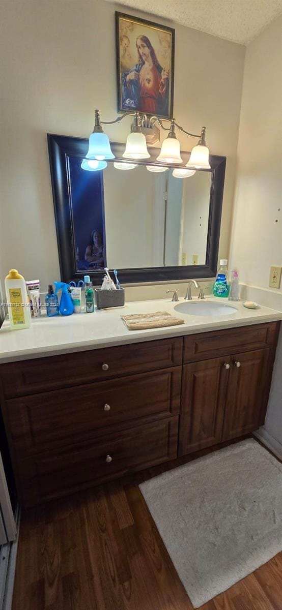 bathroom with vanity, a textured ceiling, and hardwood / wood-style floors