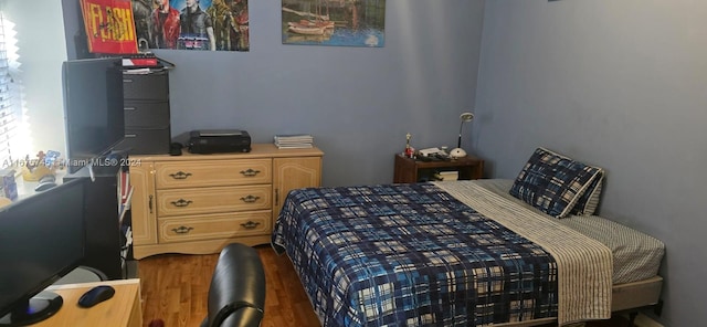 bedroom featuring dark hardwood / wood-style flooring