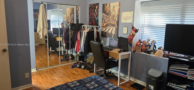 home office with hardwood / wood-style flooring