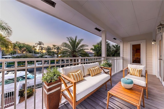 balcony at dusk with an outdoor hangout area