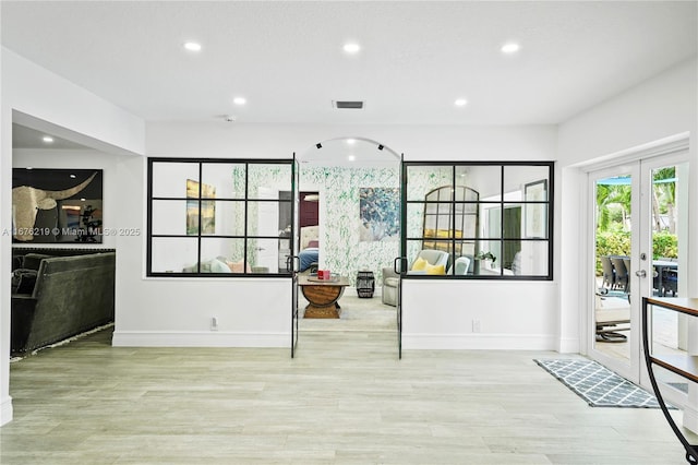 interior space with french doors and light wood-type flooring