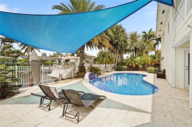 view of swimming pool with a patio and pool water feature