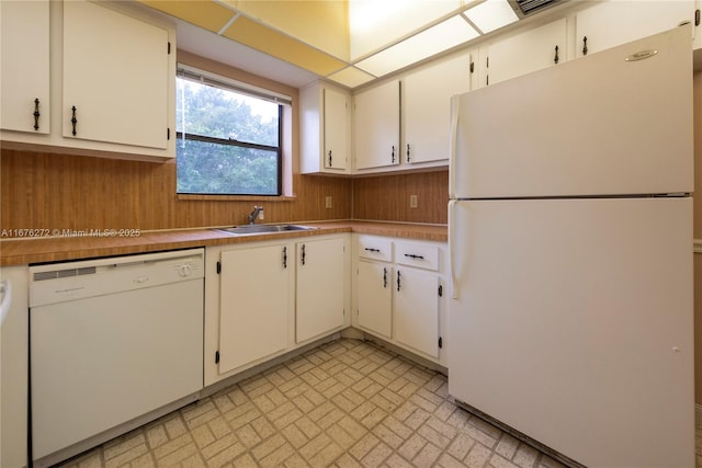 kitchen with white cabinetry, sink, and white appliances