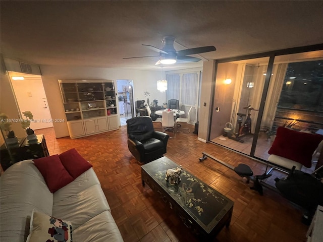 living room featuring ceiling fan and parquet flooring