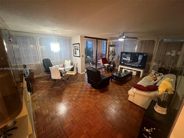 living room with ceiling fan and a textured ceiling