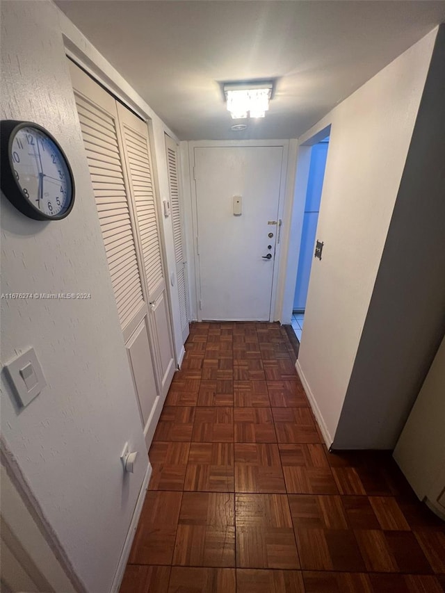 hallway featuring dark parquet floors