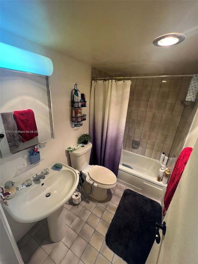 bathroom featuring tile patterned floors, shower / bath combo with shower curtain, and toilet