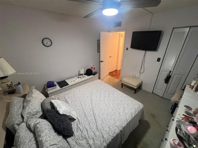 carpeted bedroom with a closet and ceiling fan