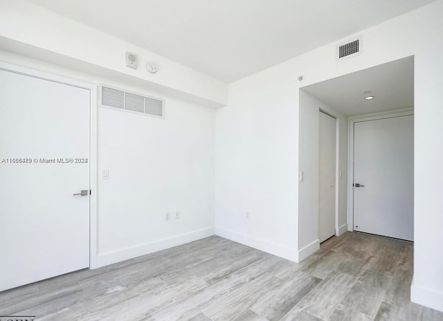 empty room with light hardwood / wood-style floors