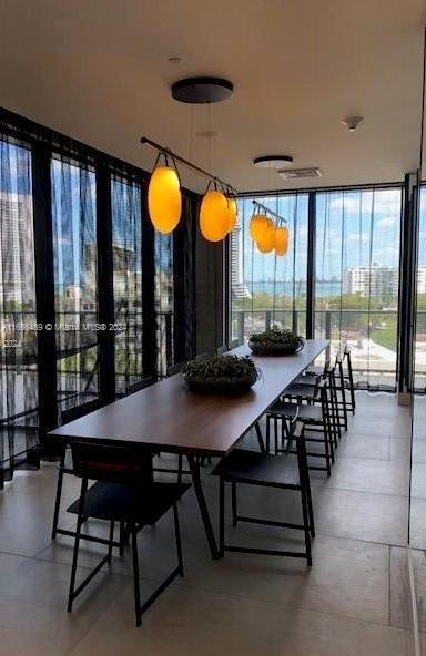 dining area with french doors and expansive windows