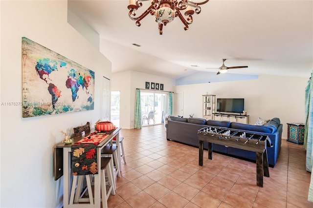 tiled living room with ceiling fan and lofted ceiling