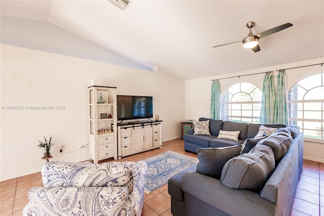 tiled living room featuring ceiling fan, plenty of natural light, and vaulted ceiling