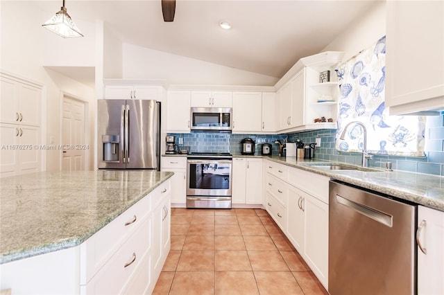 kitchen featuring appliances with stainless steel finishes, sink, lofted ceiling, and white cabinetry