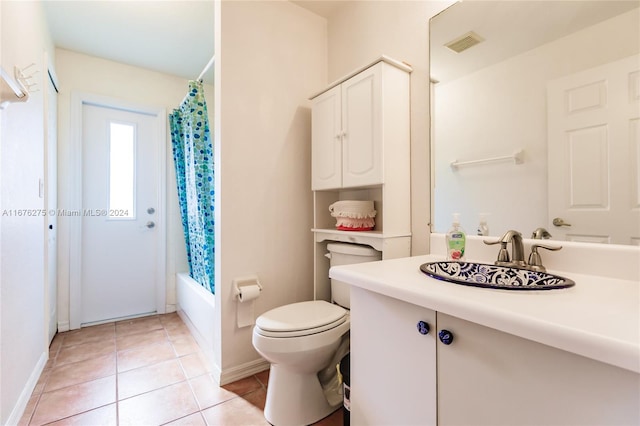 full bathroom with tile patterned flooring, toilet, shower / bath combo with shower curtain, and vanity