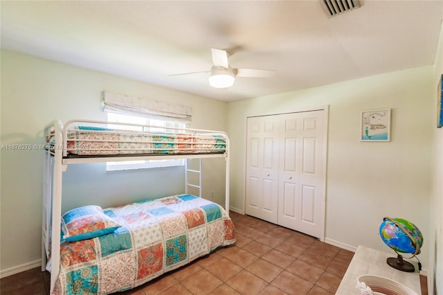 bedroom with ceiling fan, a closet, and light tile patterned floors