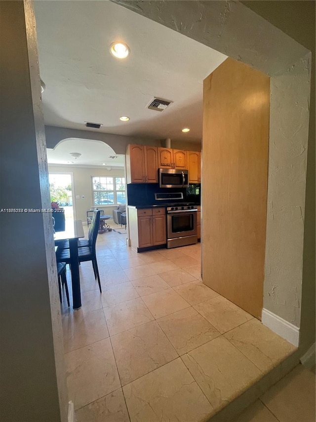 kitchen with appliances with stainless steel finishes and light tile patterned flooring