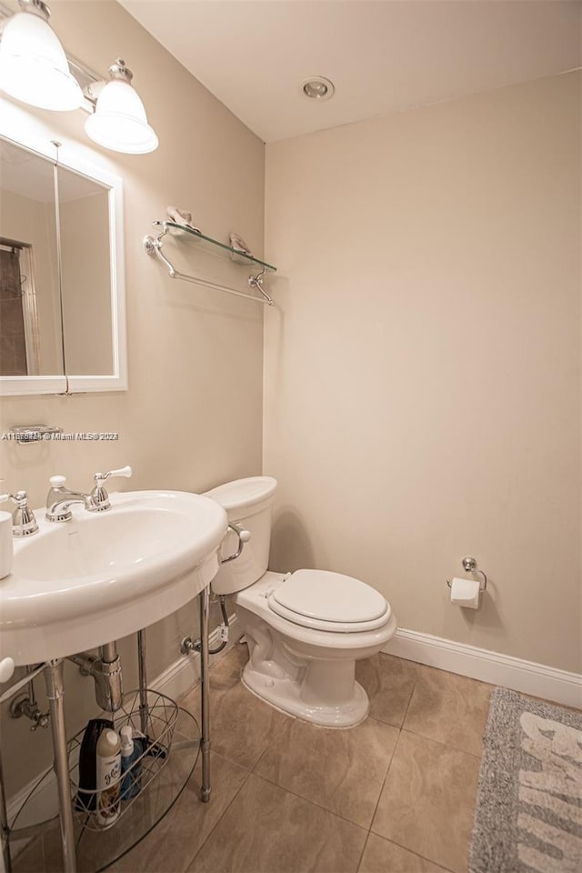 bathroom featuring toilet and tile patterned floors