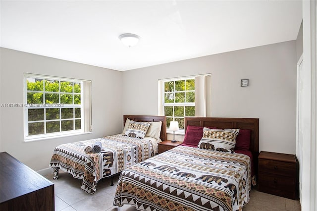 tiled bedroom featuring multiple windows