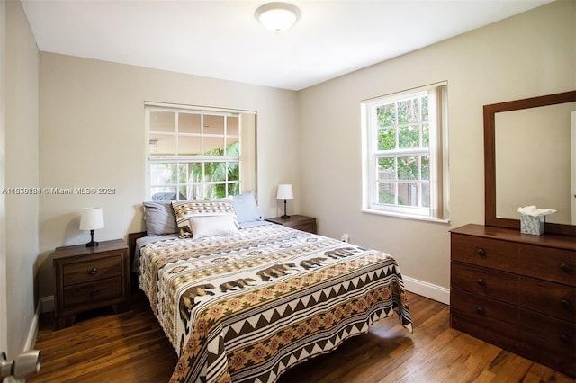 bedroom featuring wood finished floors and baseboards