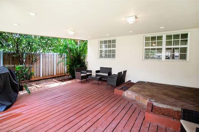 deck with outdoor lounge area, a grill, and a patio