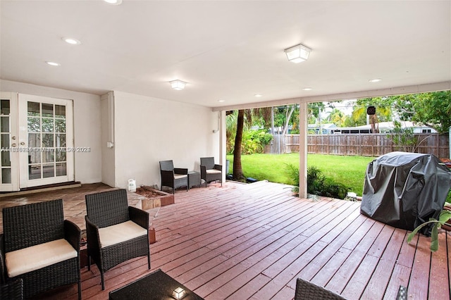 wooden deck featuring a yard and grilling area