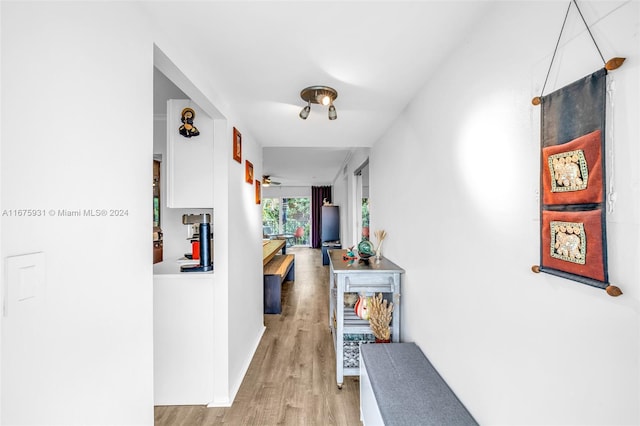 corridor with light hardwood / wood-style floors