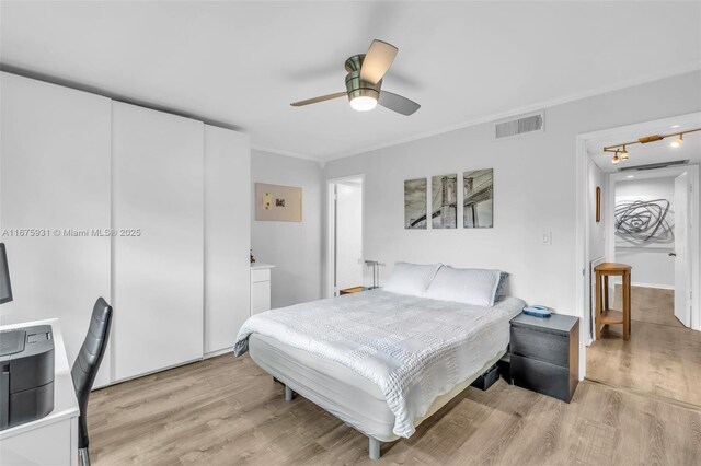 bedroom with ceiling fan and light hardwood / wood-style flooring