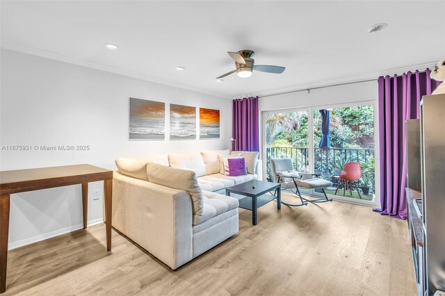 living room featuring ceiling fan, ornamental molding, and light hardwood / wood-style floors