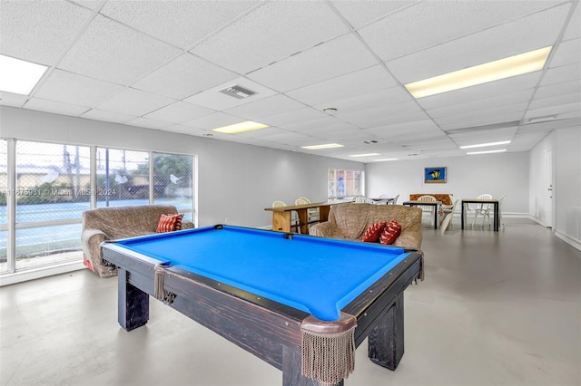 recreation room with pool table, a paneled ceiling, and concrete floors