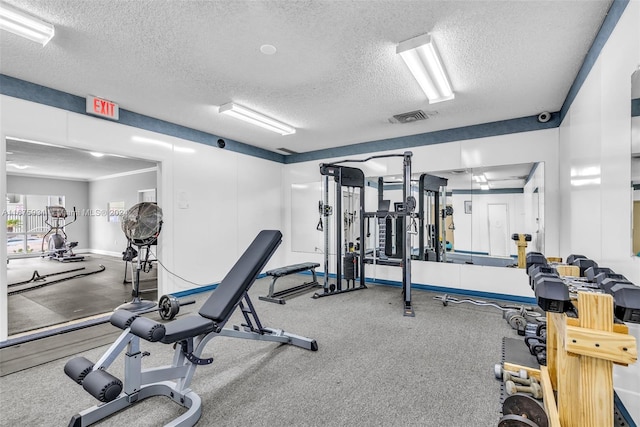 exercise room featuring a textured ceiling