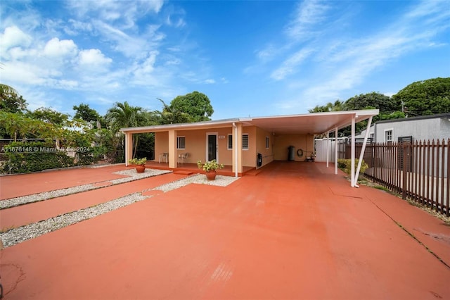 rear view of property featuring a carport