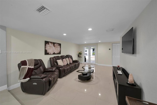 tiled living room featuring french doors