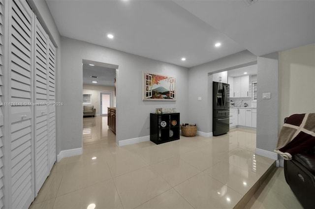 hall with light tile patterned floors