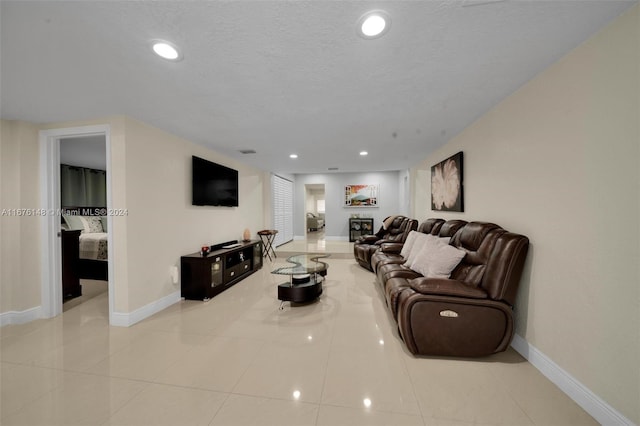 tiled living room with a textured ceiling