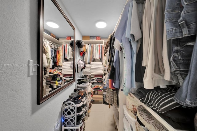 spacious closet with tile patterned floors