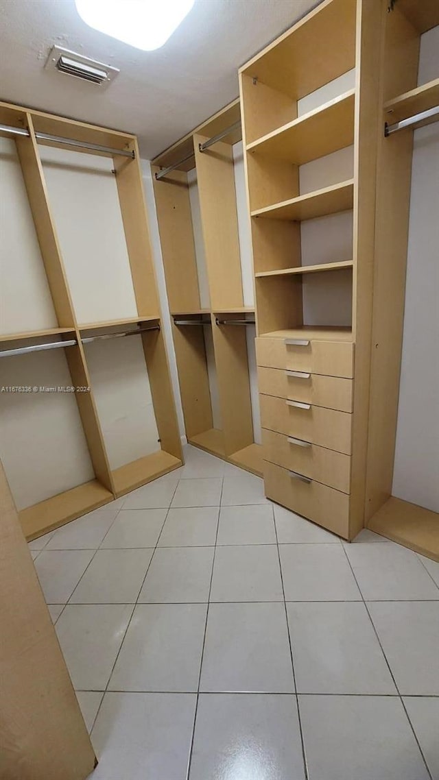 spacious closet with light tile patterned floors