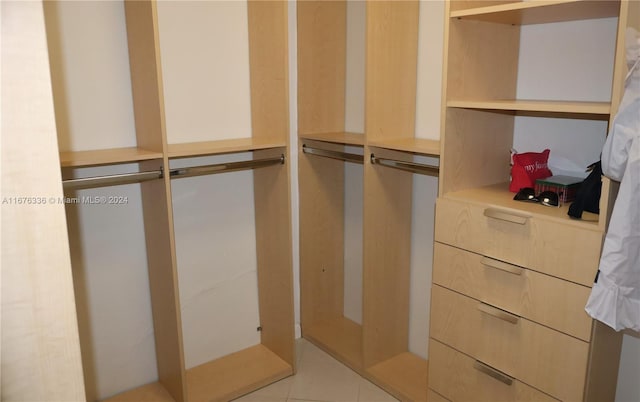 spacious closet featuring light tile patterned floors