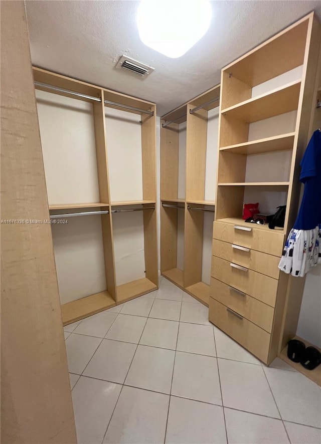 spacious closet featuring light tile patterned floors and visible vents