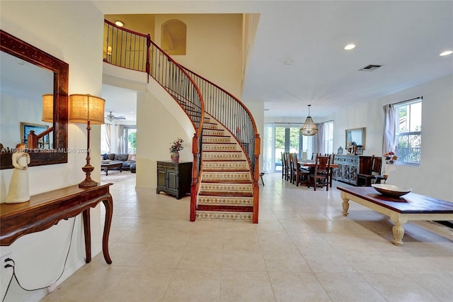 stairs featuring tile patterned floors and a wealth of natural light