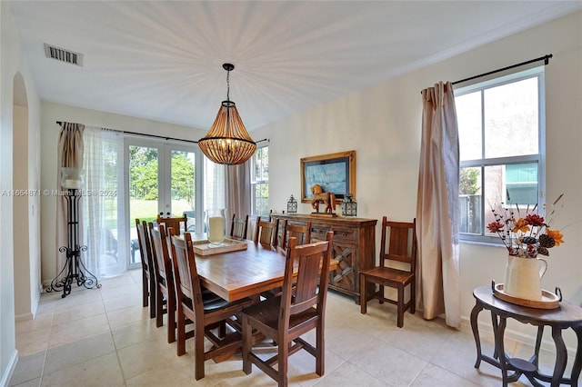 dining room featuring french doors, plenty of natural light, and light tile patterned floors