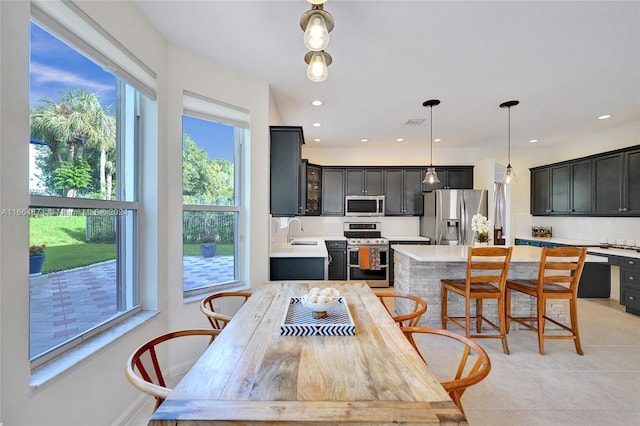 dining space with sink and light tile patterned floors