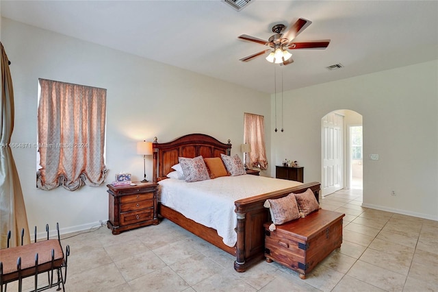 tiled bedroom featuring ceiling fan