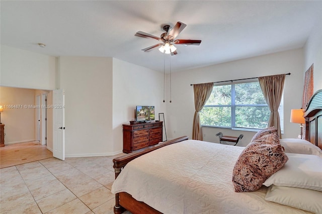 tiled bedroom featuring ceiling fan