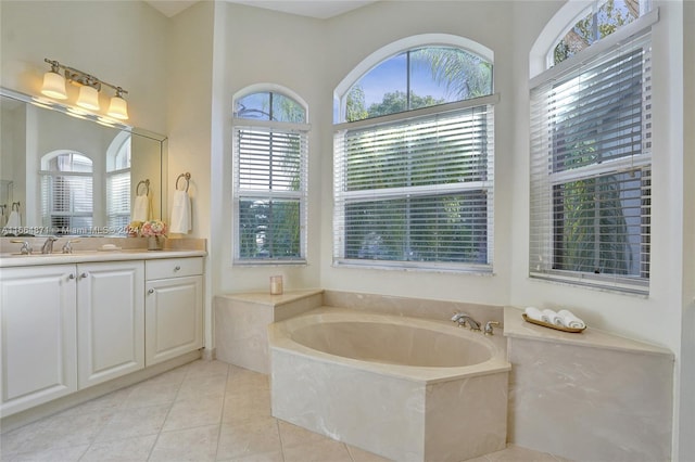 bathroom featuring vanity, a tub to relax in, and tile patterned floors